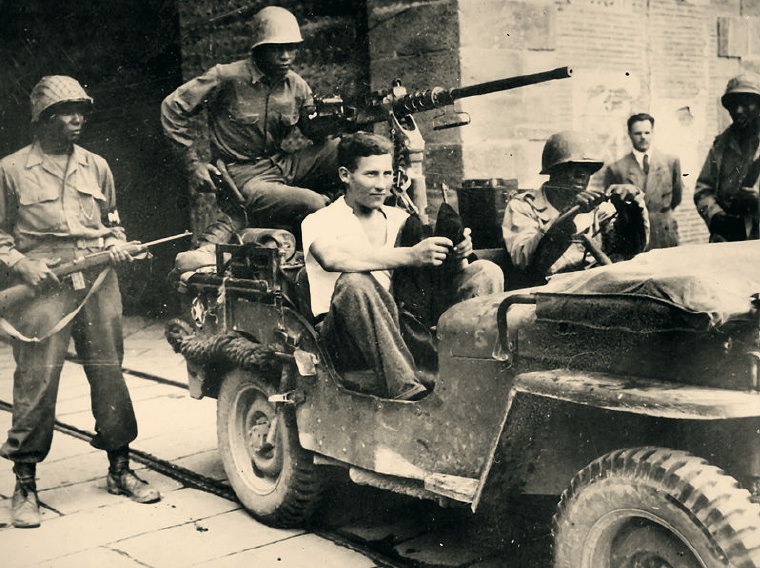 92nd Division troops escorting a German POW